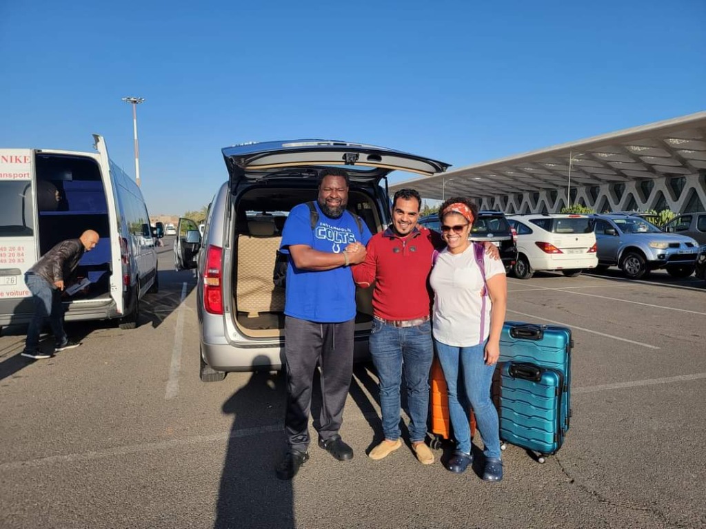 Happy travelers posing with driver