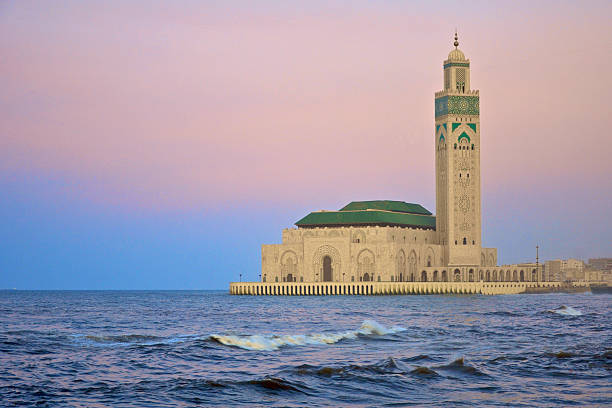 Hassan II Mosque in Casablanca at sunset with turquoise dome over the ocean